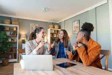 Entrepreneurial Friends with Laptop in Home Office