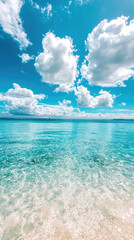 Tropical beach with crystal clear water and fluffy white clouds