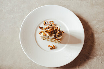 coffee almonds cake in white plate on loft background