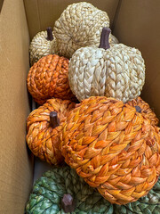 Halloween pumpkin decorations in a cardboard box