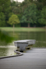 THE WOODLANDS, TEXAS - AUGUST 12th, 2024: Rob Fleming Park looks picturesque on a cloudy day. The shimmering lake and fountain reflect beautifully, while stone and wooden structures add to its chic.