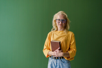 Young Woman with Notebook Ready to Jot Ideas