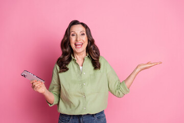 Photo portrait of grandmother in khaki shirt holding arm promoting social medias account isolated...