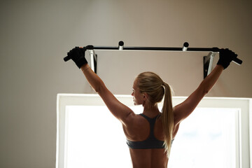 Strong back, pull up or woman in gym for exercise, power and workout for fitness, body health or...