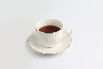 Obraz premium white cup of coffee with white saucer on white background