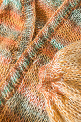 Knitted fashion. Autumn and winter wardrobe. Cozy home. Warm things. Knitting pattern. Chunky knitting. Striped clothes. Self-made cardigan. Craft product. Bright knitted mohair cardigan.