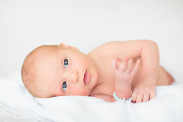 Little baby on white bed