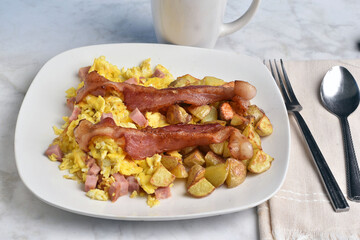 scramble eggs with diced spam with home fries and bacon
