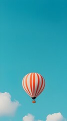 Naklejka premium Vibrant Hot Air Balloon Ascending into the Vast Azure Sky