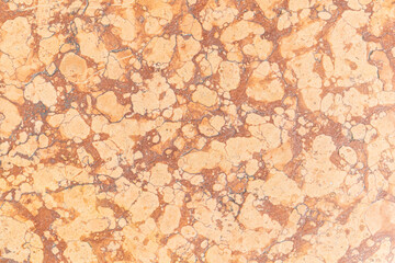 marble surface, known for its smooth texture and elegant appearance. Marble is commonly used in various architectural and design