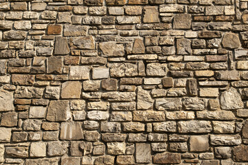 stone wall made of limestone, typical of ancient cities. The craftsmanship of stonemasons is evident in the construction.