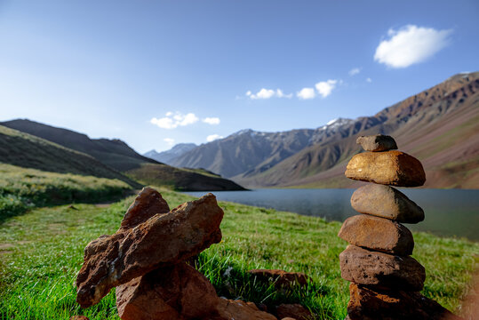 Chandratal lake, Moon Lake during Sunset with crystal clear water in between mountains surrounded by snowcapped mountains.