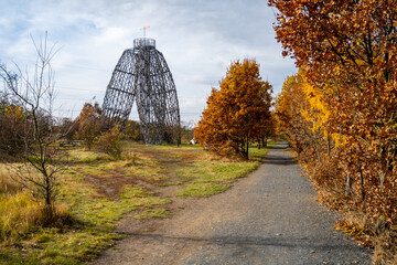 The Doubravka Lookout Tower stands tall amidst vibrant autumn foliage in Prague, providing a scenic...