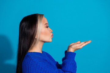Photo portrait of attractive young woman profile send air kiss empty space dressed knitwear clothes...