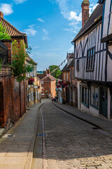 A view down a quaint street leading away from the Cathedral in Lincoln, Lincolnshire in summertime