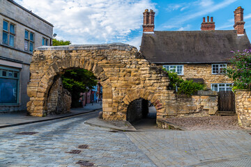 A view towards the old Roman Newport Arch entrance gate into Lincoln, Lincolnshire in summertime