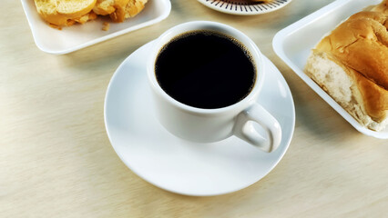 Cup of coffee in the center of breakfast table.
