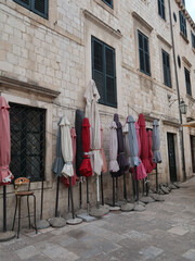 Umbrellas in front of a stone wall 