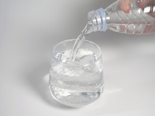Pour Water Into Empty Glass Isolated On White Background