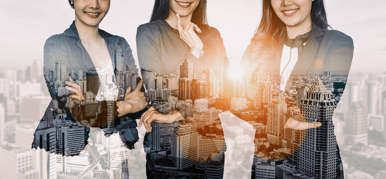 Double exposure image of many business people conference group meeting on city office building in background showing partnership success of business deal. Concept of teamwork, trust and agreement.