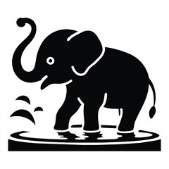 Fototapeta premium A young elephant plays in shallow water splashing droplets into the air while enjoying its time under the warm sun in a natural habitat