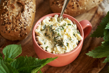 A cup of homemade nettle butter with sourdough bread