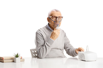 Senior sitting and using a nebulizer