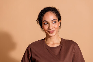 Photo of lovely sweet adorable woman wear stylish clothes look empty space isolated on beige color background