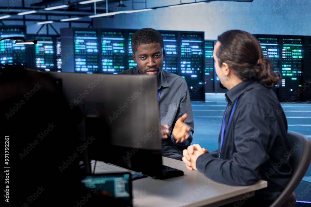Poster system administrators reconfiguring server room to optimize it for data processing requirements of c