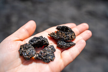 A girl holds a lava stone in her hands, Hawaii Volcanoes National Park