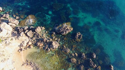 Rocky beach and sapphire sea water on the Maltese island, mediterranean sea, Ghajn Tuffieha bay , Malta. High quality photo