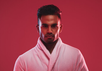 Hygiene, beauty and face portrait of man with bathrobe for body shower and cleaning on studio background. Confidence, luxury and spa treatment with aesthetic muslim man for self care grooming routine