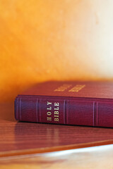 Close-up shot of a spine of the Holy Bible book in a red cover