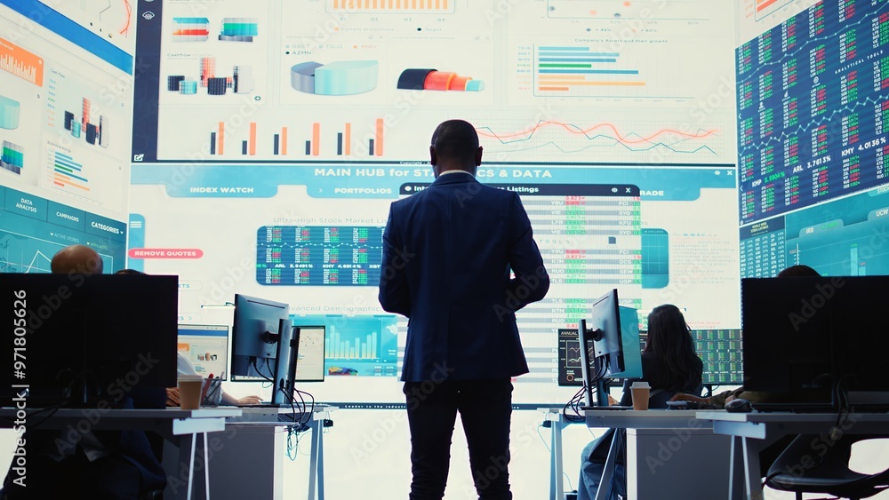 Poster administrative assistant examining important big data visualizations on a huge display, creating an 