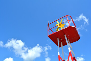 Isolated marine steel navigation buoy.  End of summer concept. Buoy on blue sky background with copyspace for text. 
