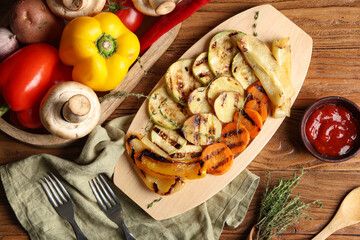 Tray with grilled vegetables on wooden background