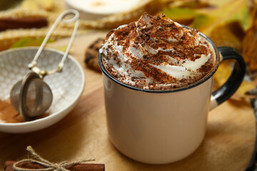 Autumn composition with cup of cocoa on wooden tray as background, closeup