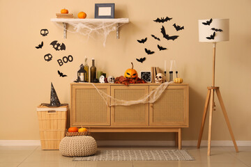 Interior of living room decorated for Halloween with commode and pumpkins
