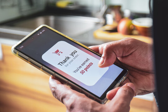 Customer loyalty program concept for marketing strategy. Man earned reward points by shopping online using mobile applications. 