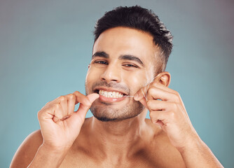 Studio, portrait and happy man with floss for dental, gum health and wellness with cleaning for...