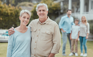 Hug, portrait and smile of old couple in garden of new home with family for property investment. Development, love or partnership and senior people with children and grandkids for real estate growth