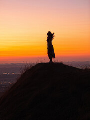 Fototapeta premium Happy Woman Enjoying Sunset View from Hilltop