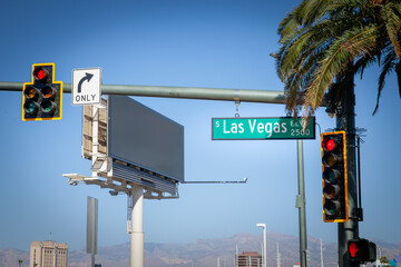 A typical American intersection on Las Vegas Boulevard (or las vegas strip), featuring traffic lights, road signs, and palm trees, symbolizing the urban landscape of Las Vegas, Nevada. © Jerome