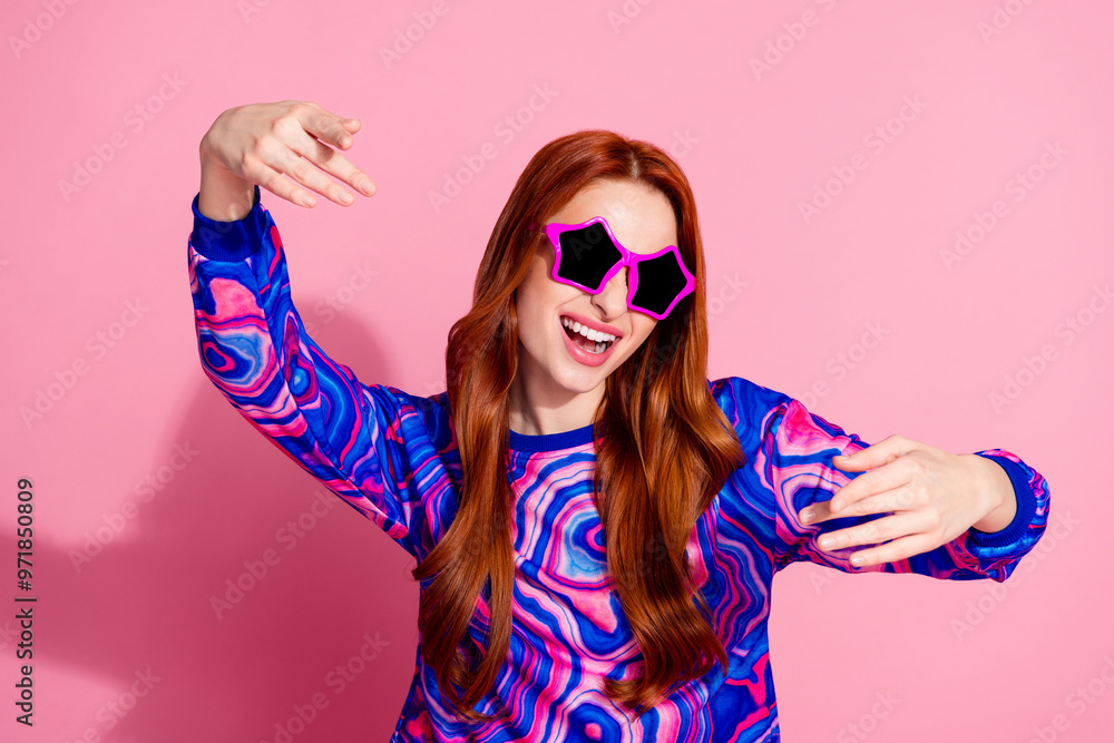 Wall mural Photo of lovely young woman dance sunglass wear pullover isolated on pink color background