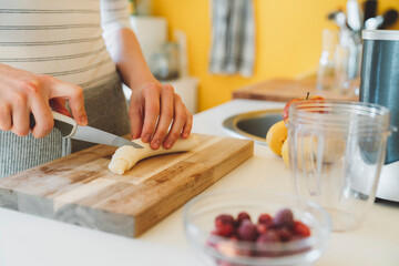 Woman preparing breakfast smoothie