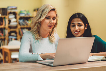 Two diverse woman working on a project together