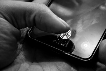 scan thumb on the fingerprint sensor of the phone screen