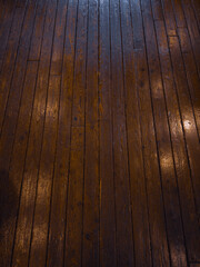 Background image of a floor made of old, wooden boards with traces of life.