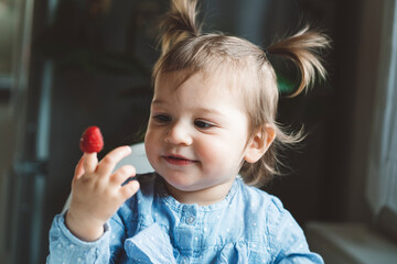 The baby is trying a new taste of solid food. Eating healthy food from the beginning is important. Young child doesn't want to eat vegetable and fruit.