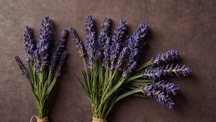 Three bundles of lavender flowers arranged on rustic wooden table.